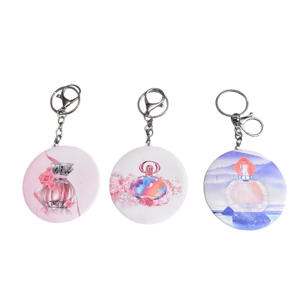 Fun perfume bottle keychain/bagcharm that opens with a mirror inside. New